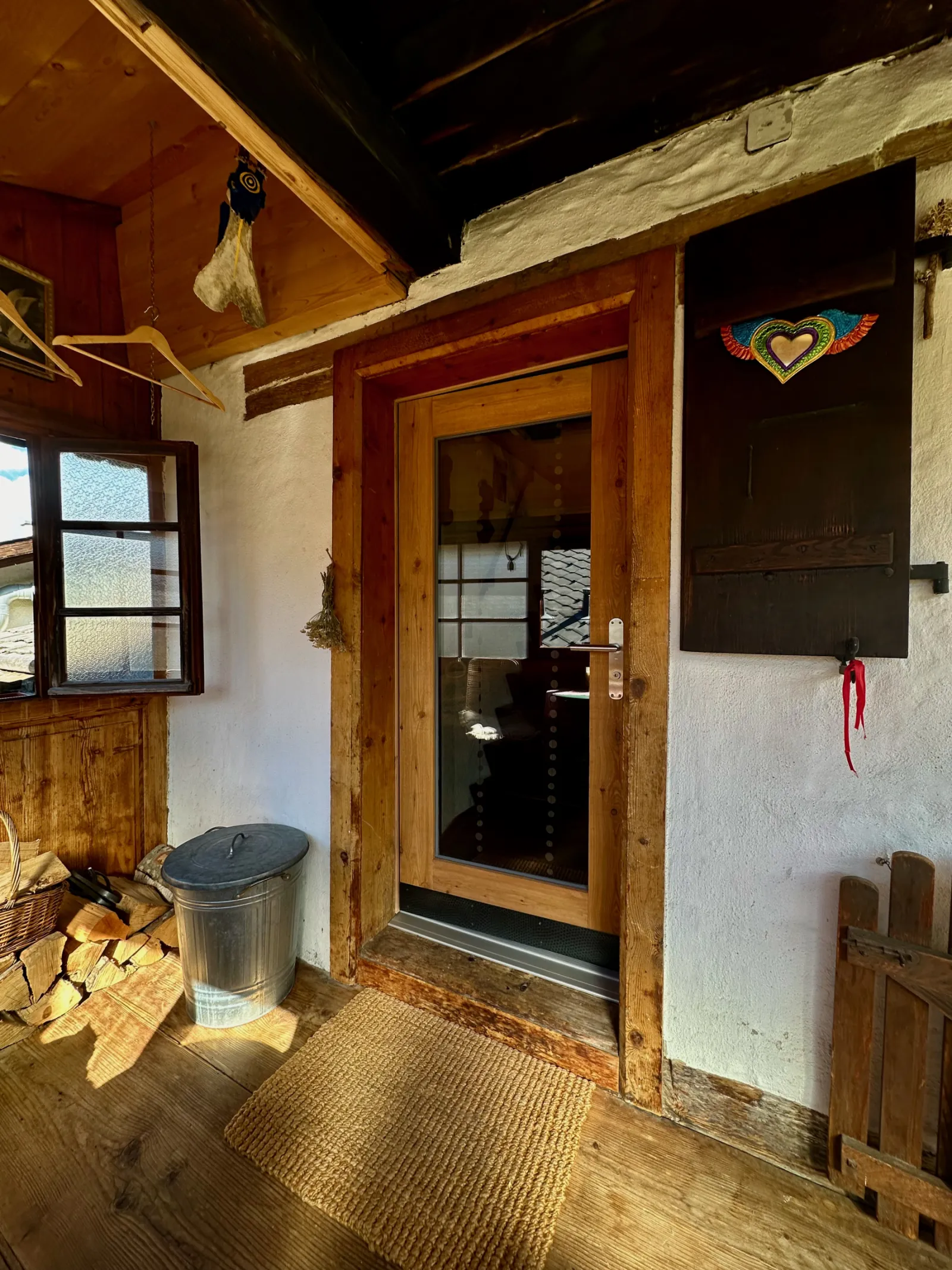 Entrée de chalet avec bois de chauffage et porte vitrée